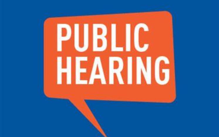 BLUE SQUARE WITH ORANGE BOX AND WORDING INSIDE READING PUBLIC HEARING